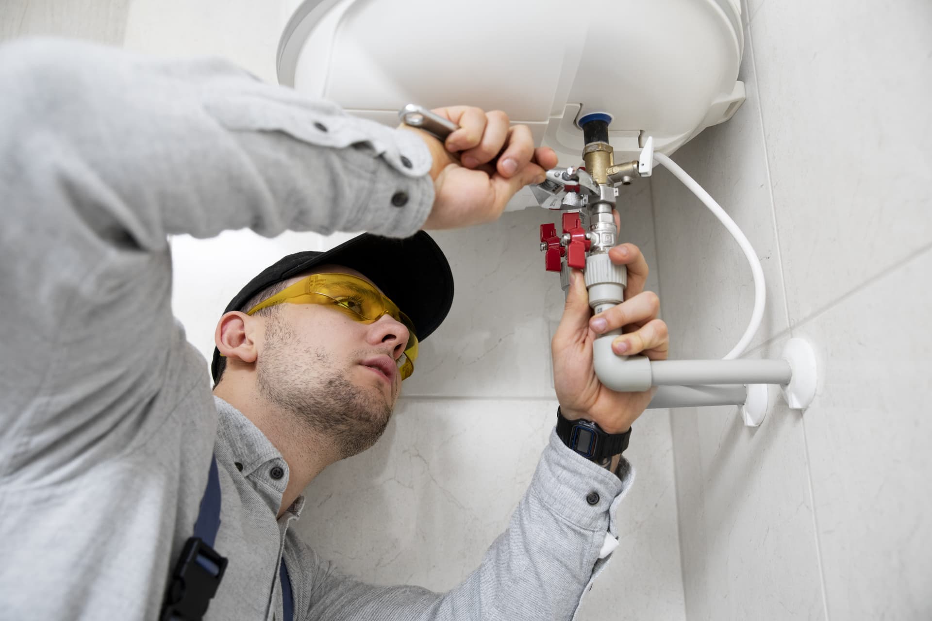 worker-repairing-water-heater-min